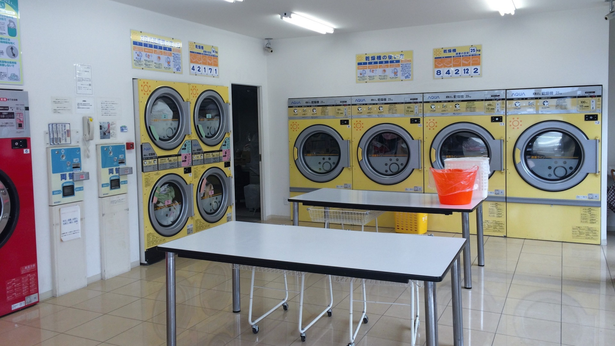 Image of a person sorting laundry at a laundry service in Lagos: "Our professional team sorting laundry for the best results in Lagos.